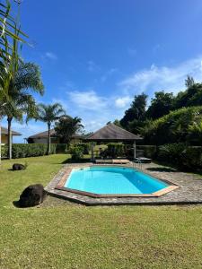 a swimming pool in the middle of a yard at Luna's Home Raiatea 