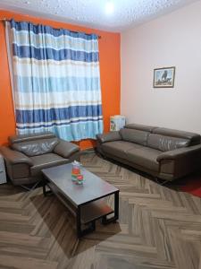 a living room with a couch and a coffee table at Mango Plaza in Homa Bay
