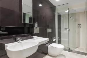 a bathroom with a white sink and a shower at Great Southern Hotel Melbourne in Melbourne +45 photos