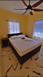 a bedroom with a bed with a bird on it at Peaceful in Town in Saint Georgeʼs