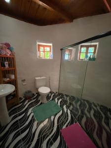 a bathroom with a zebra print floor with a toilet and a sink at Casa Principal in Itapeva +22 photos