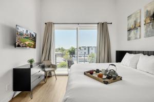 a bedroom with a bed and a desk and a window at Thunderbird - 4 Units - Jacuzzi - In Old Town in Scottsdale +101 photos