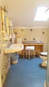 a bathroom with a sink and a toilet at Albergo Savoia in Ospedaletti