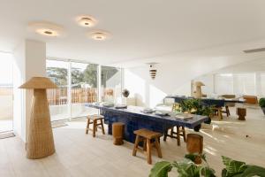 a living room with a blue table and chairs at Marina Resort in Nelson Bay