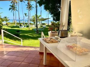 a white table with a bowl of fruit on it at Hotel TODOBLANCO, Las Galeras, SAMANA in Las Galeras