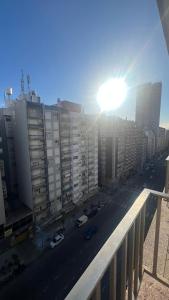 a view of a city street with buildings and the sun at Studio Arena y Sol - MDQ Güemes in Mar del Plata +8 photos