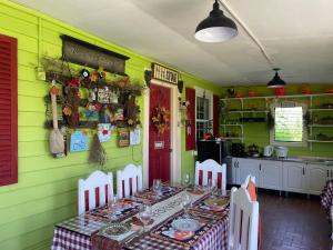 a dining room with a table in a green room at Madie's Place Guest House in Santa Rosa
