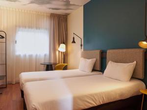 Кровать или кровати в номере Ibis Madrid Aeropuerto Barajas