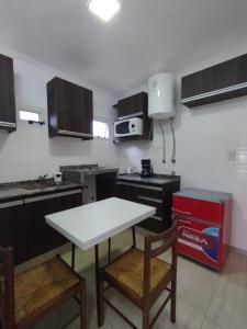 a kitchen with a white table and chairs in it at Catalina - Excelente ubicacion en pleno centro - 1B in Santa Fe