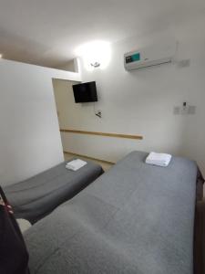a room with two beds and a tv on the wall at Catalina - Excelente ubicacion en pleno centro - 1B in Santa Fe