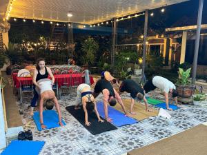 a group of people doing a yoga pose on a mat at Tam Coc Sunrise Homestay in Ninh Binh