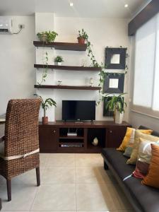 a living room with a couch and a tv at Kennedy Norte Suites in Guayaquil