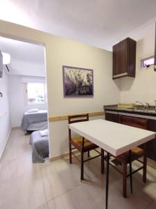 a kitchen with a table in the middle of a room at Catalina - Excelente ubicacion en pleno centro - 1B in Santa Fe