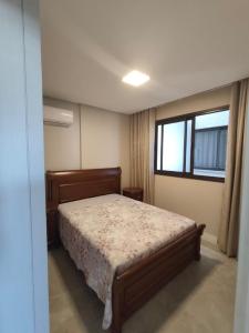 una camera da letto con un letto e una finestra di Apartmento em Castelhanos a 50 metros da praia a Anchieta
