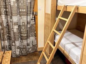 a bunk bed with a ladder in a room at Appartement chaleureux près des pistes à Méribel - FR-1-688-100 in Mussillon
