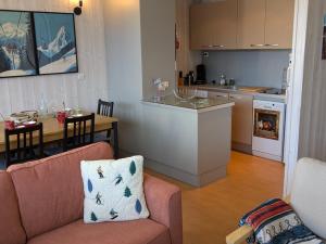 une cuisine et un salon avec un canapé et une table dans l'établissement Appartement lumineux 3 pièces 6/7 pers à Orcières Merlette - FR-1-262-192, à Forest des Baniols
