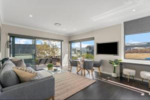 a living room with a couch and a table at Beachfront Studio Surf Side in Cams Wharf