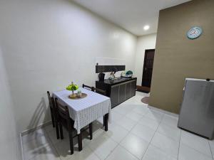 a kitchen with a table with chairs and a counter at Homestay Tok Ani by Ardzman Hospitality in Permatang Pauh