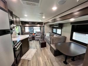 a kitchen and living room of an rv at Comfortable 1BR RV for mid-to-long term stays in Beaumont