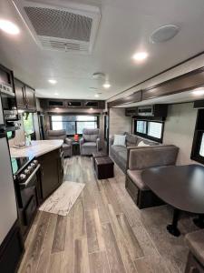 an rv living room with a couch and a table at Comfortable 1BR RV for mid-to-long term stays in Beaumont