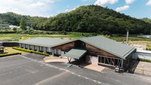 an aerial view of a building with a parking lot at みずほガーデンロッジ in Kyotamba