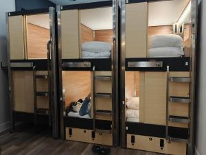 a group of three bunk beds in a room at I Street Capsule Hostel in Washington, D.C.