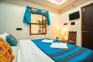 a bedroom with a bed and a desk and a window at Heart and Soul of Jaisalmer in Jaisalmer