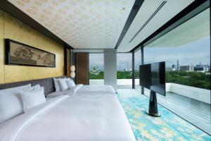 a bedroom with two beds and a flat screen tv at Espacio Nagoya Castle in Nagoya