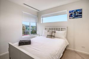 a bedroom with a large bed with a window at Relaxed Family Stay Walk to Beach in Ocean Grove