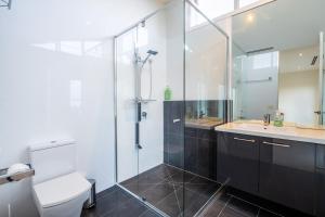 a bathroom with a shower and a toilet and a sink at Relaxed Family Stay Walk to Beach in Ocean Grove +35 photos