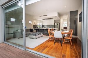 a kitchen and living room with a table and chairs at Relaxed Family Stay Walk to Beach in Ocean Grove