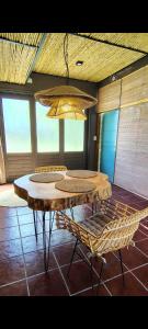 une pièce avec une table, des chaises et un lustre dans l'établissement Brasa Loft de Campo, à Colonia Las Rosas