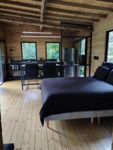 a bedroom with a bed and a table and chairs at Refugio Madremonte in Medellín