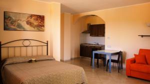 A bed or beds in a room at Rosso Di Sera