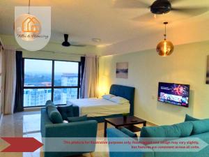 a living room with a couch and a bed and a tv at ImpianKU at HYVE SOHO Cyberjaya - Studio - Wifi in Cyberjaya