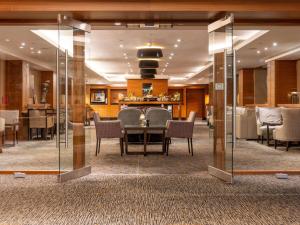 a dining room with a table and chairs at Sofitel London Heathrow in Hillingdon +43 photos