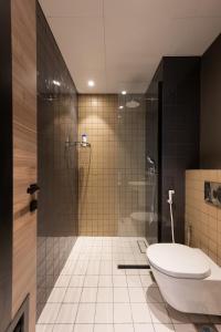 a bathroom with a toilet and a glass shower at Elegant space Studio by Spacey Duqm 82 in Duqm