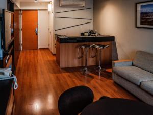 a living room with a couch and a table at Novotel Lima San Isidro in Lima