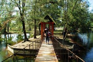 a person walking across a bridge over a river at Greenlast Hotel in Kuantan