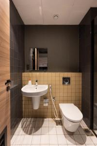 a bathroom with a sink and a toilet at Luxury home away Studio by Spacey Duqm 81 in Duqm +8 photos