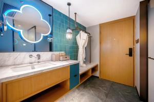 a bathroom with a sink and a cloud sign on the wall at Rosewood Chengdu in Chengdu +35 photos
