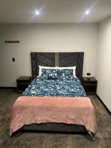 a bedroom with a large bed and two night stands at Cabaña Yará in Dosquebradas