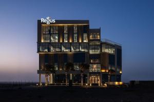 a building with a sign on top of it at Chic gateway Studio by Spacey Duqm 80 in Duqm