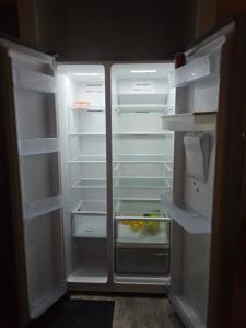 an open refrigerator with its door open and its shelves at Aragon Demi-Apartment Baldivis in Baldivis