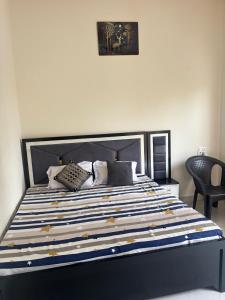 um quarto com uma cama com um edredom azul e branco em Hari Dham em Vrindāvan