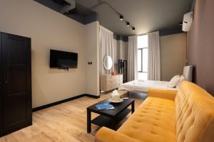 a living room with a couch and a bed at Relax in style Studio by Spacey Duqm 79 in Duqm