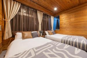 Postel nebo postele na pokoji v ubytování Shinjuku Homely Stay