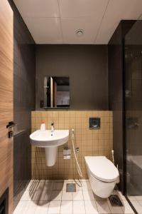 a bathroom with a sink and a toilet at Work meets comfort Studio by Spacey Duqm 78 in Duqm