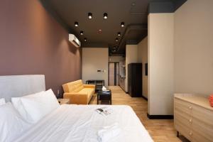 a bedroom with a bed and a living room at Work meets comfort Studio by Spacey Duqm 78 in Duqm