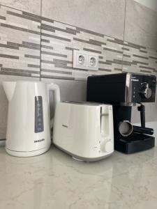 a toaster and coffee maker sitting on a counter at Mountain View Apartment in Sibiu